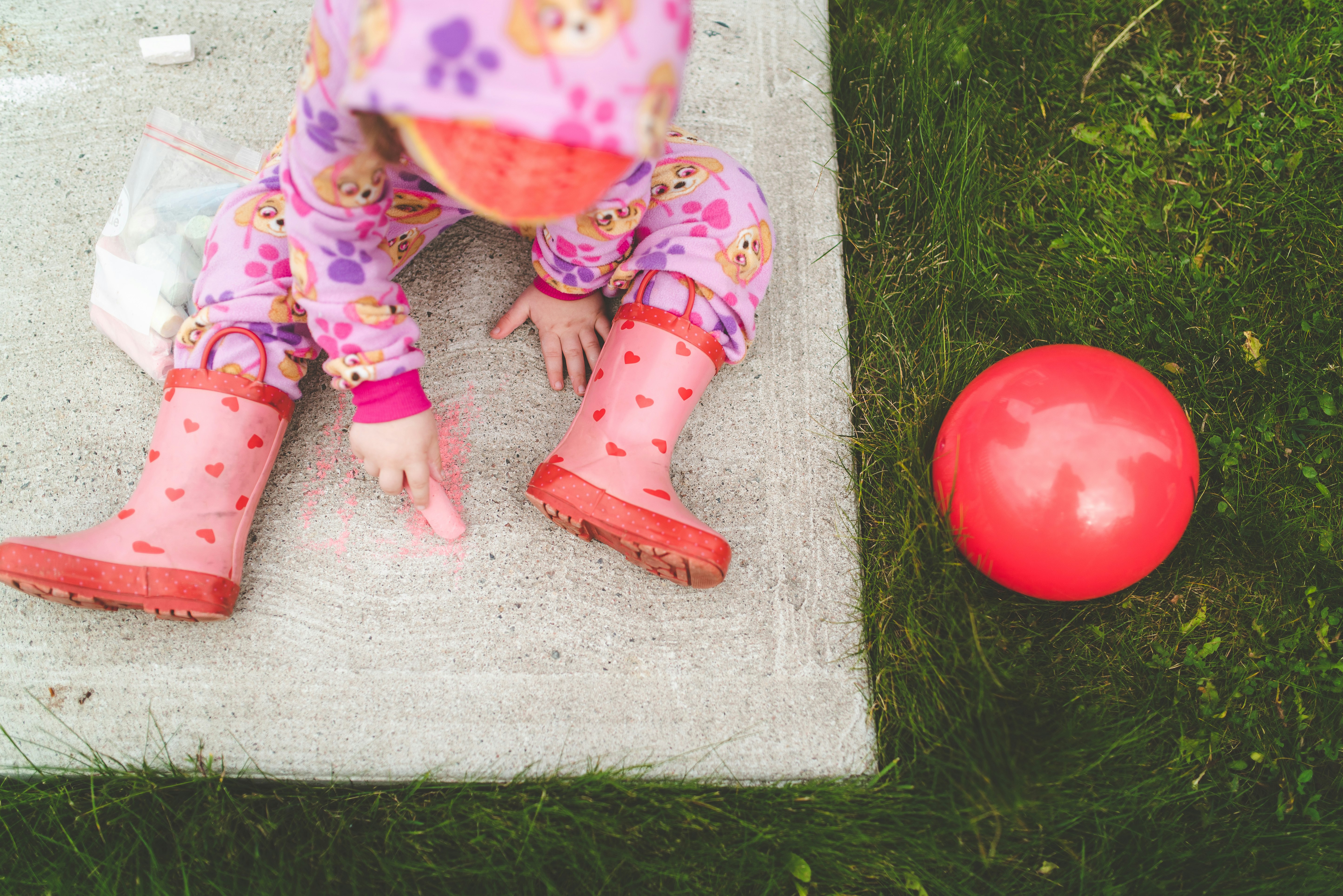 child in pink and white polka dot pants and pink and white polka dot socks